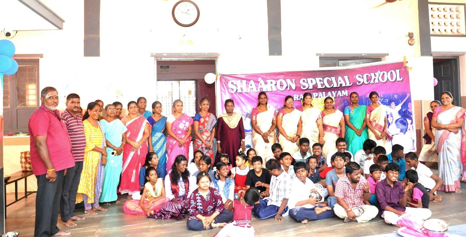 Students, teachers and staff of Shaaron Special School gathered together in the school hall in front of the Annual Day banner